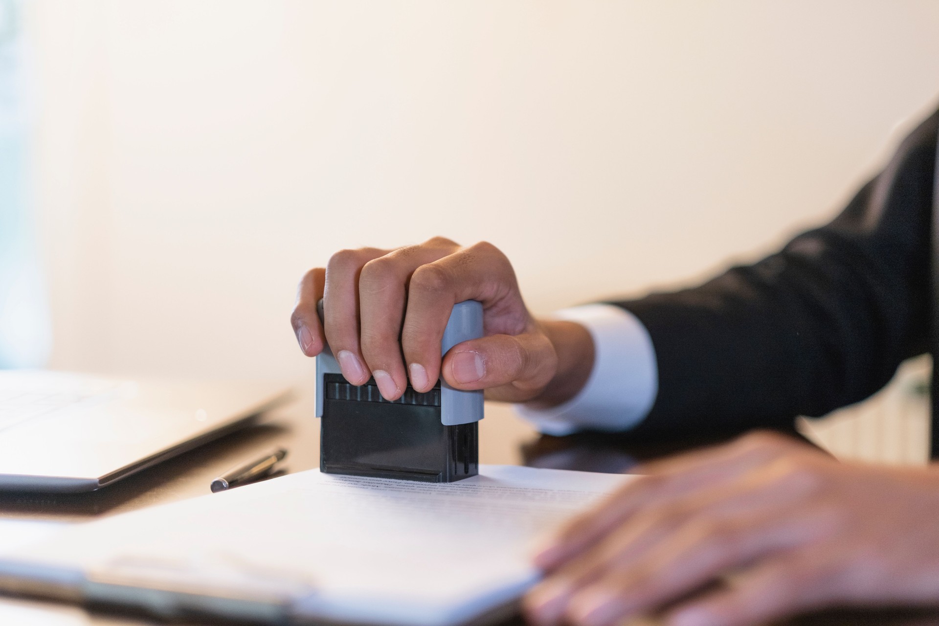 Businessman stamping a document at his desk