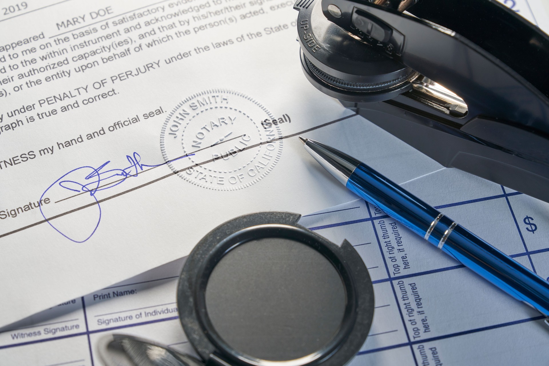 Notary Public: Seal embossed on document with pen on journal