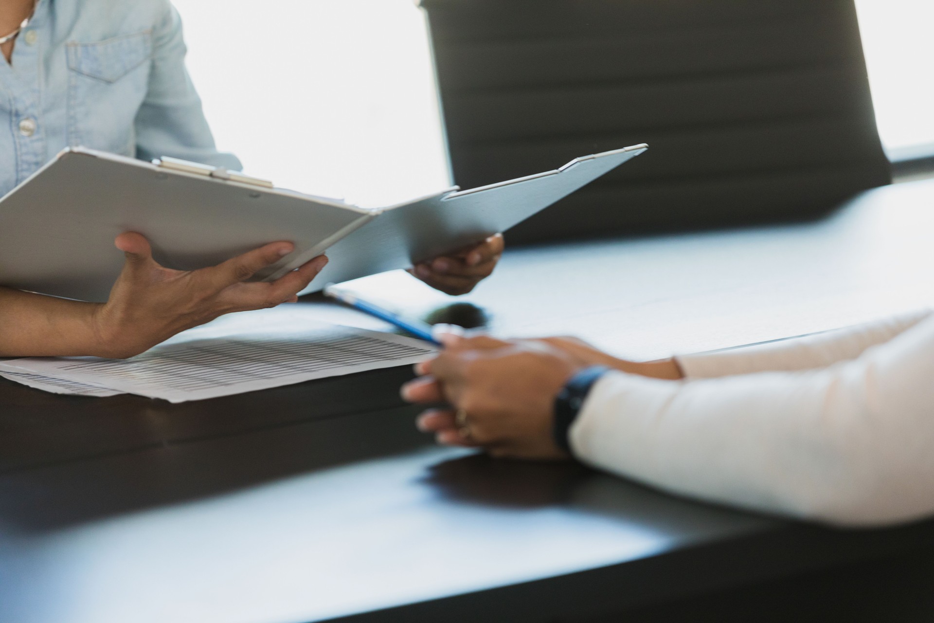 Unrecognizable female manager interviews unrecognizable woman